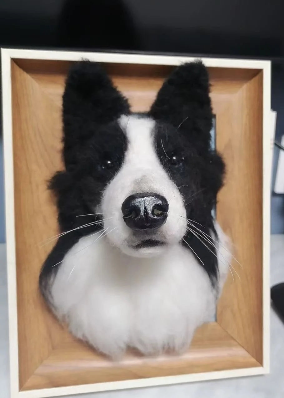 Faux taxidermy of a dog head in a wooden frame on a dark background