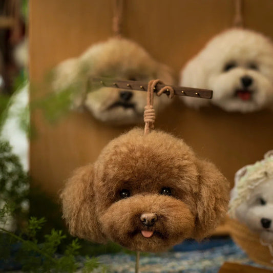Plush dog toys hanging on a rack with a focus on a brown plush dog toy.