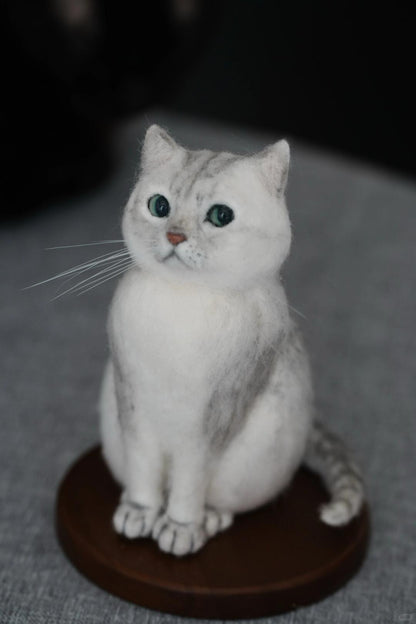 White cat figurine on a gray surface