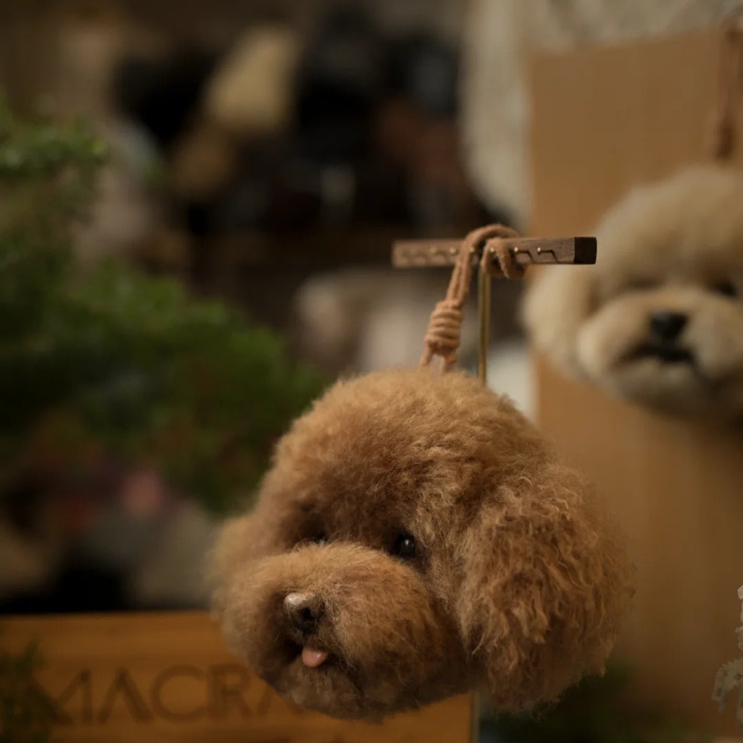 Small brown dog toy hanging from a stick with a blurred background