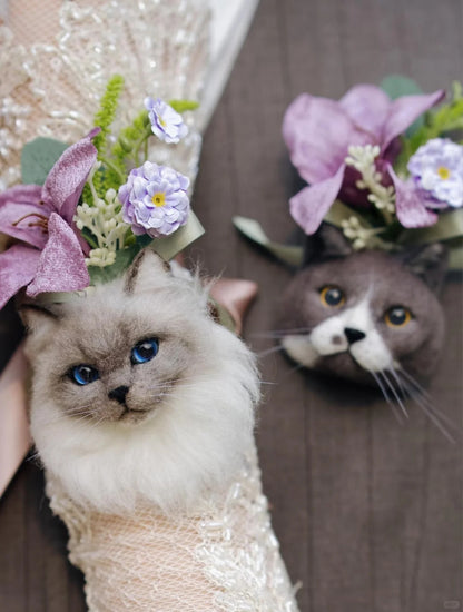 Two cats wearing flower crowns, one in a wedding dress, on a wooden floor.