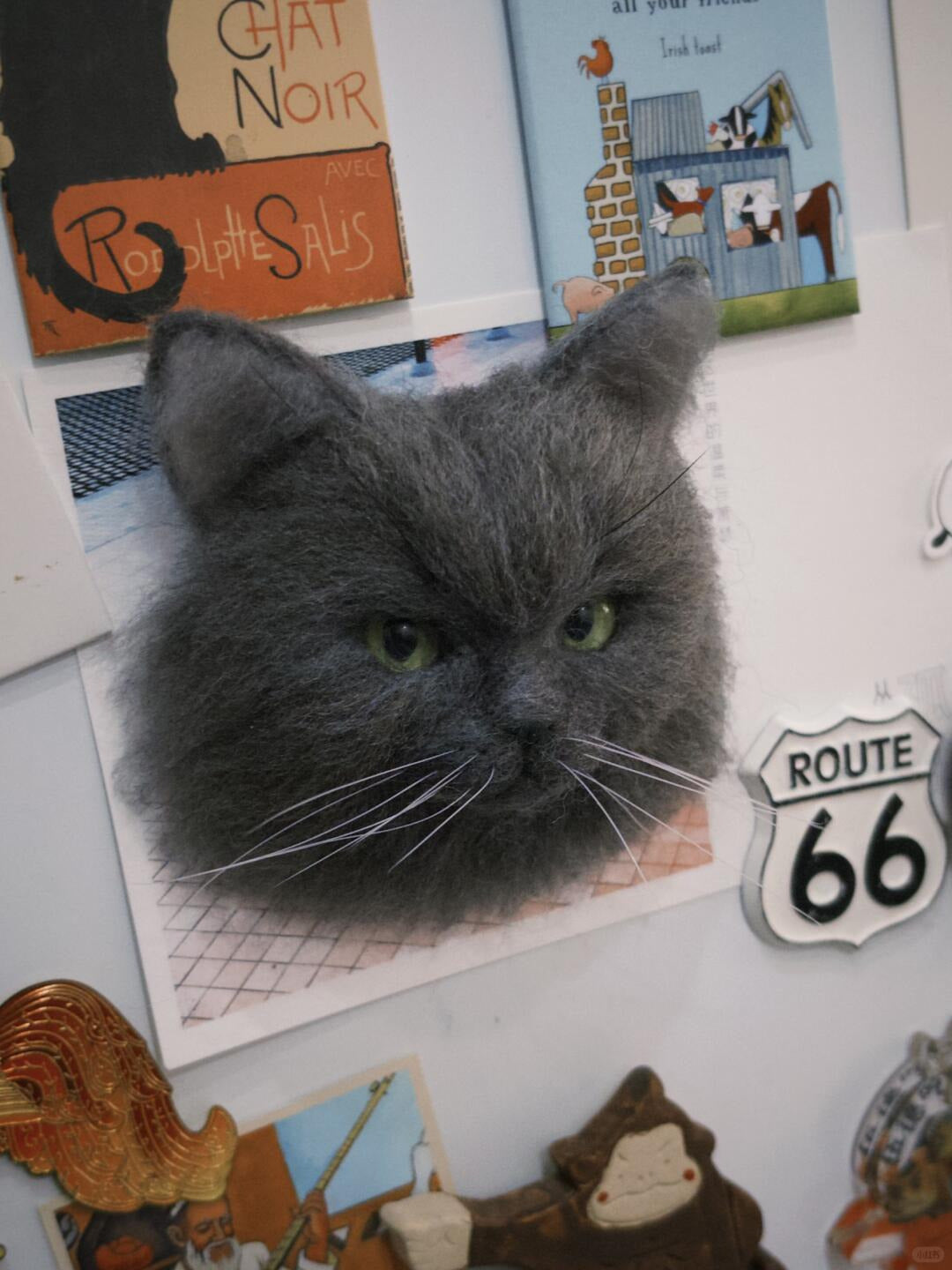 Gray cat with a vintage-themed background featuring signs and posters.