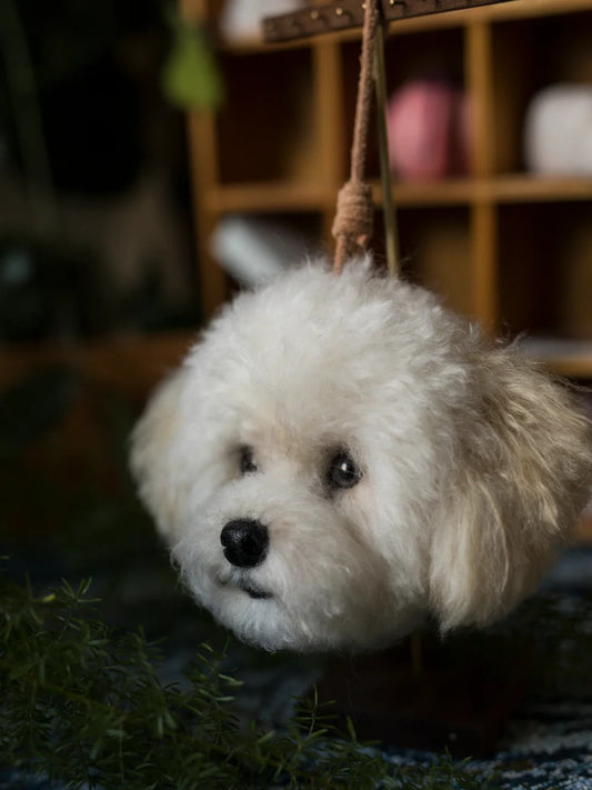 White dog toy hanging from a string with a blurred indoor background