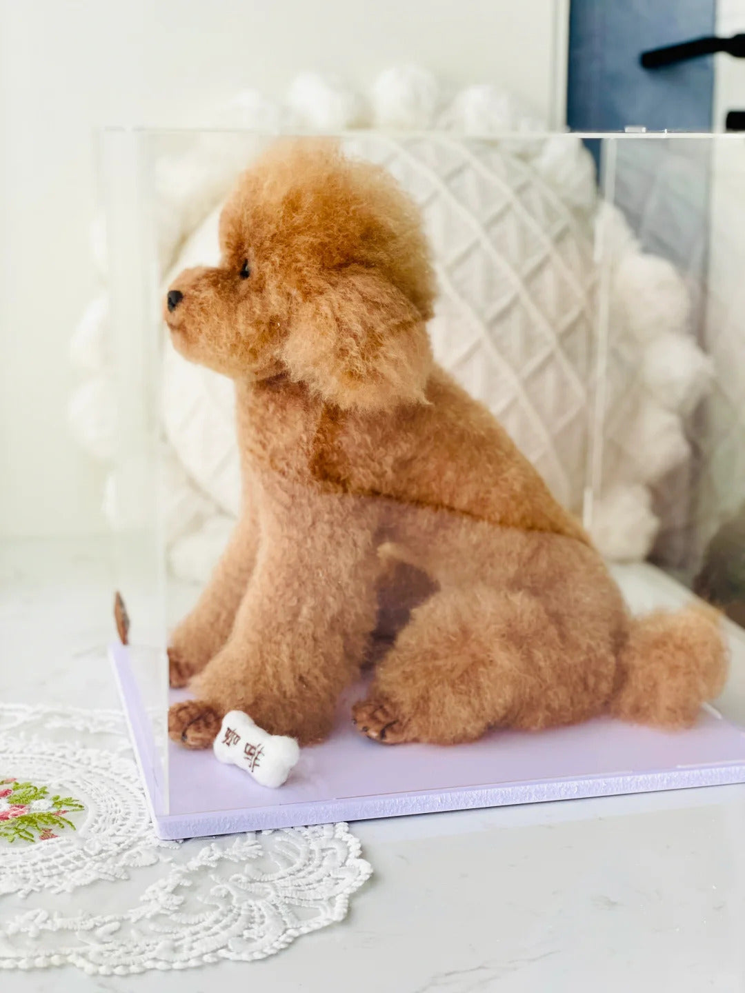 Brown dog sitting on a white surface with a decorative background
